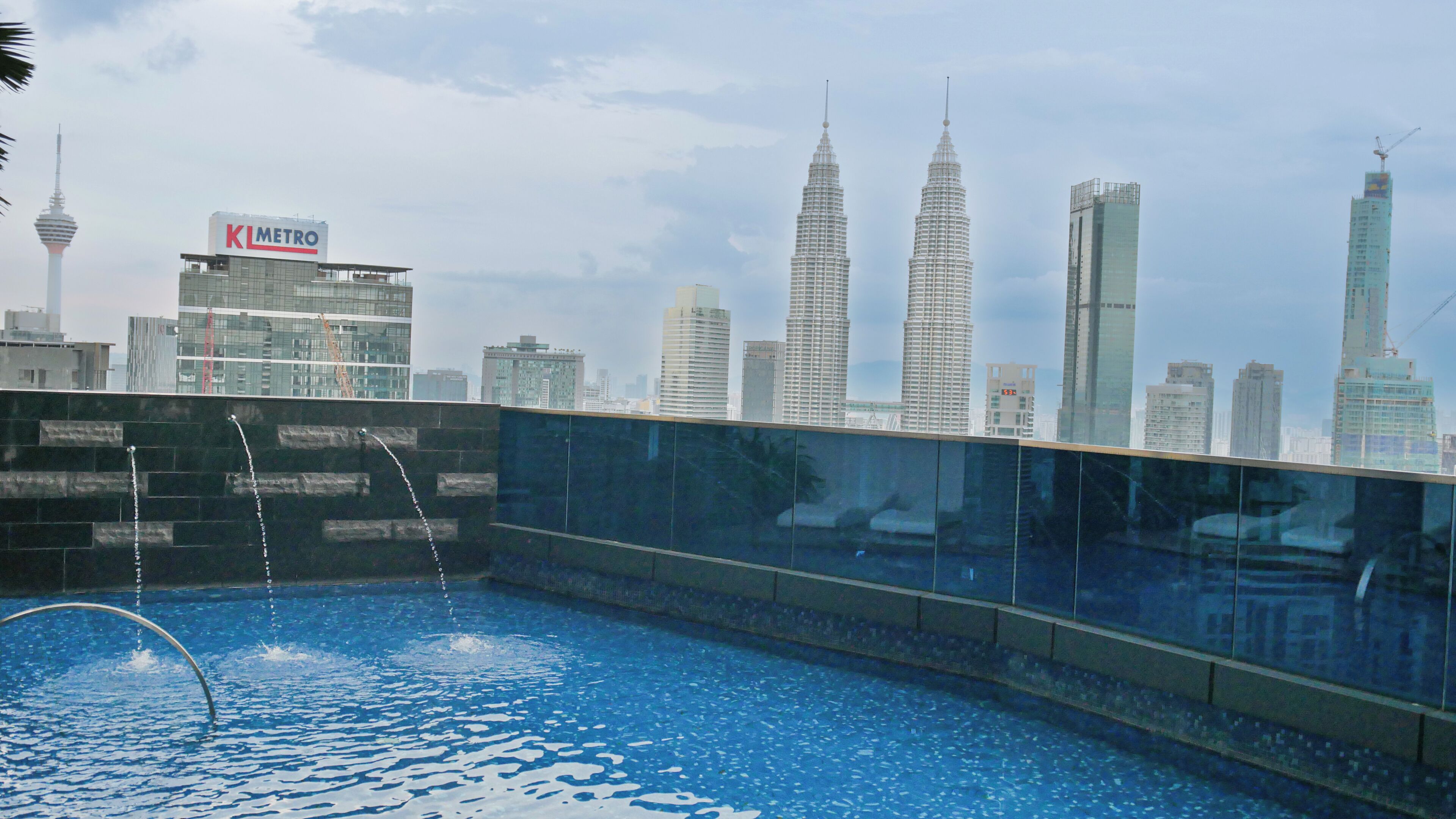 A rooftop pool with a city skyline in the background.