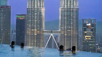 A view of the Petronas Twin Towers with a reflection in a body of water.