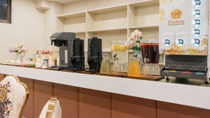 A coffee station with multiple coffee makers and a beverage dispenser. - Fleurs Resort & Hotel (Nishio)