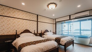 A hotel room with two beds, floral wallpaper, a large window with a view, and a modern bathroom. - Fleurs Resort & Hotel (Nishio)