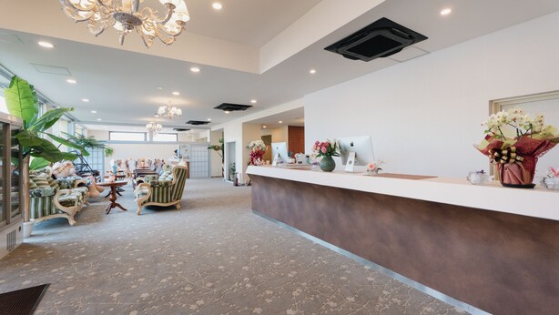 A spacious lobby with a reception desk, seating area, and decorative plants. - Fleurs Resort & Hotel (Nishio)