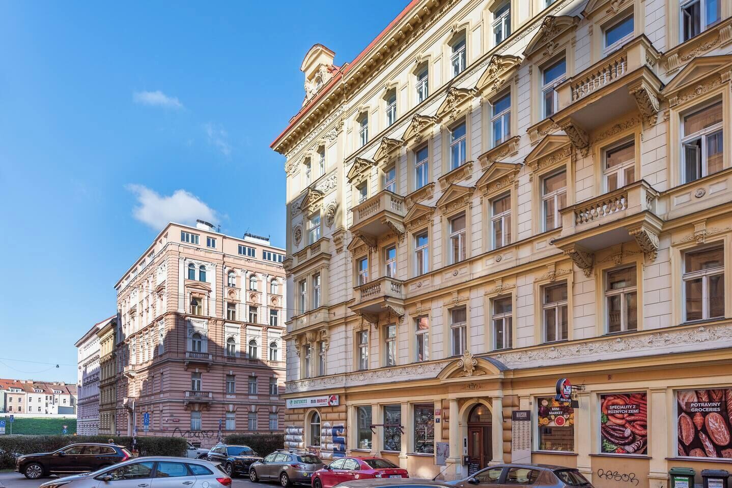 A multi-story building with classical architecture, featuring ornate balconies and large windows.