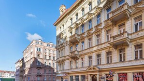 A multi-story building with classical architecture, featuring ornate balconies and large windows. - Bright Duplex Loft near Wenceslas Square (Prague 2)