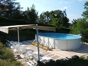An outdoor swimming pool with a covered area and lounge chairs. - 2 Personen by Interhome (Labruguière)