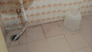 A bathroom with a white sink, two faucets, and a toilet. - Hotel Jayalakshmi Residency (Tirupati)