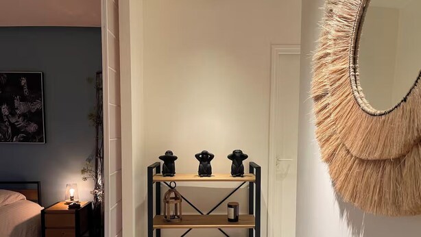 A bedroom with a bed, bedside table, lamp, and a wall-mounted mirror. - Maison d’architecte lumineuse • Au cœur des Vosges (Deyvillers)