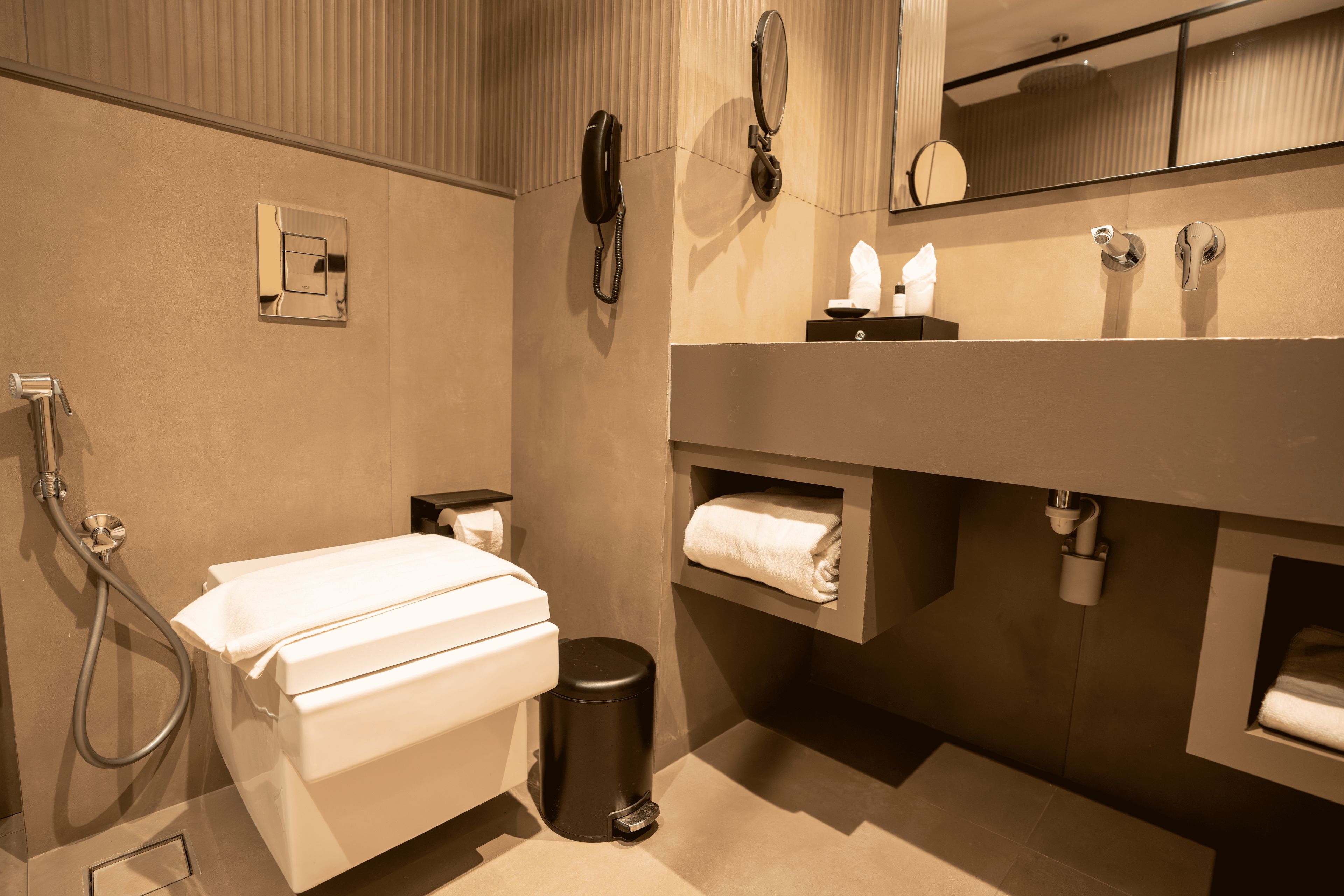 A modern bathroom with a shower, toilet, and vanity.