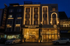 A hotel named 'The Queen's Head Boutique Hotel' with a prominent entrance and a visible sign. - The Queens Head - City Centre (New Delhi)