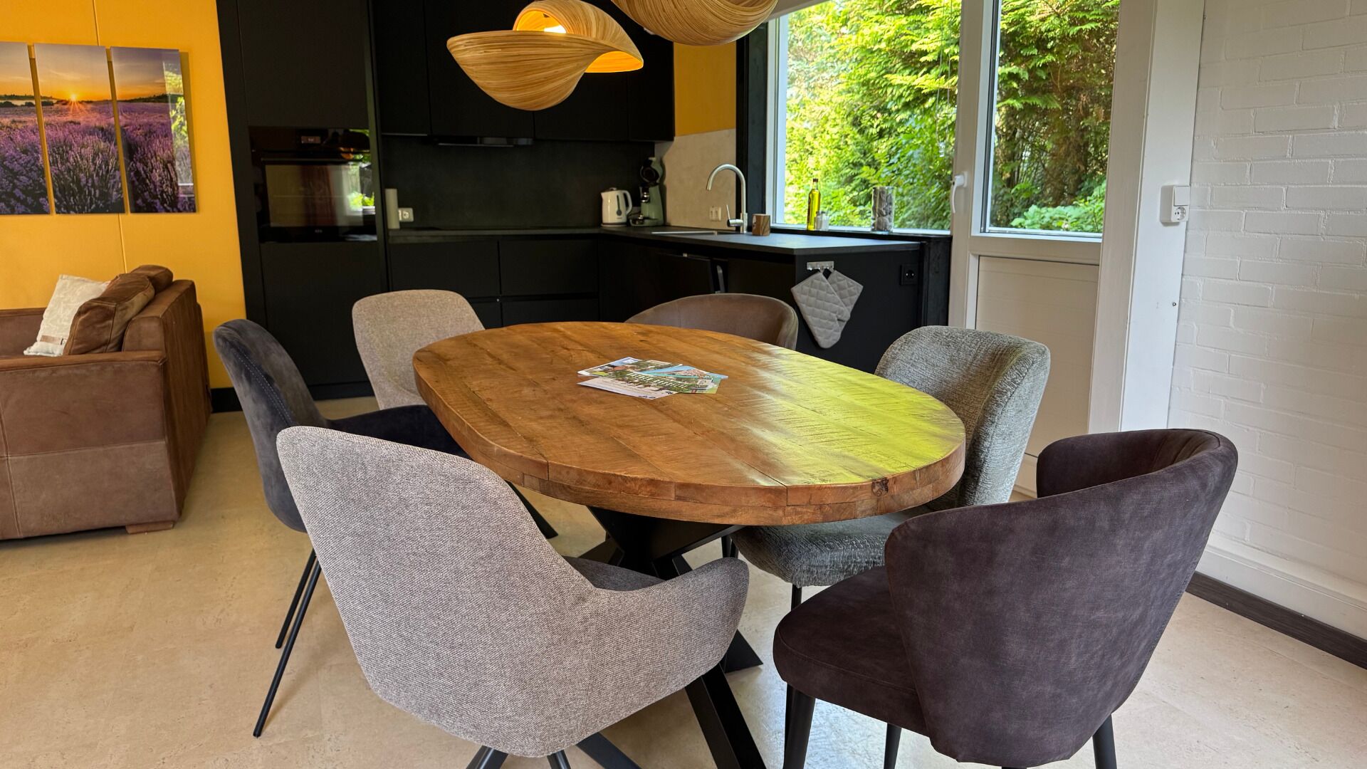 A modern kitchen with a dining area featuring a wooden table and four chairs.