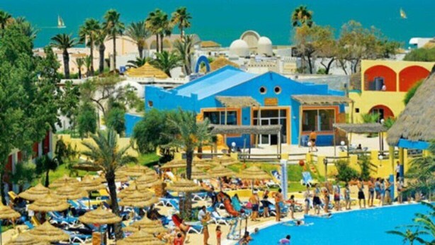 A resort with a swimming pool, beach umbrellas, and palm trees. - Caribbean World Borj cedria   (Borj Cédria)