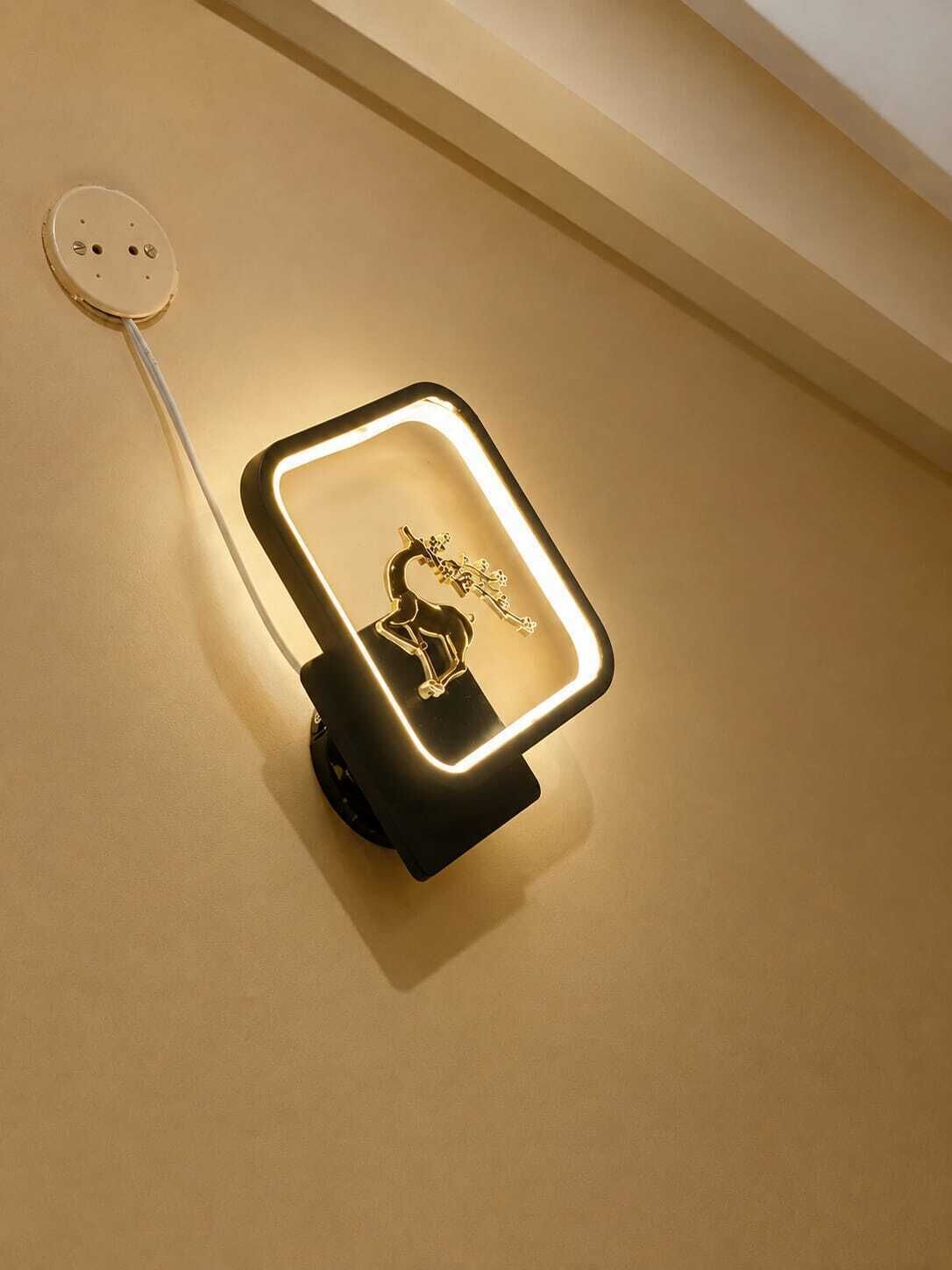 A wall-mounted light fixture with a guitar design, connected to a power outlet.