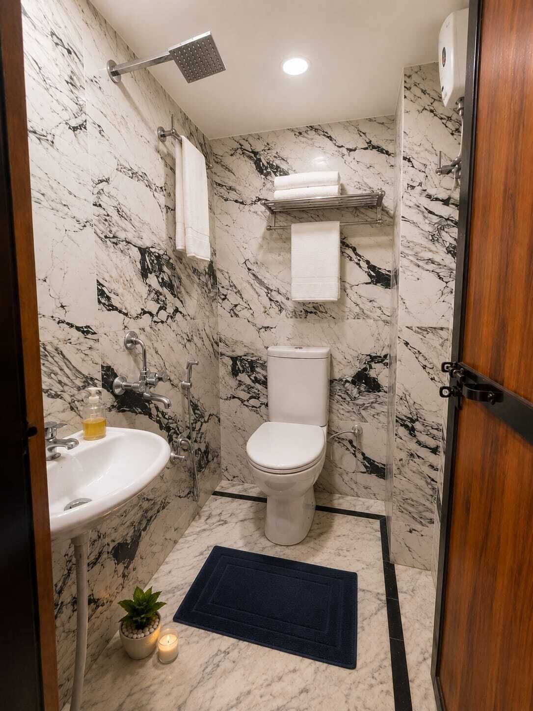 A bathroom with a toilet, sink, and shower.