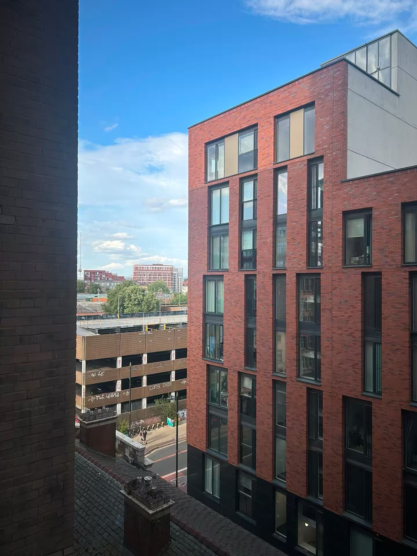 A multi-story building with a brick facade and large windows.