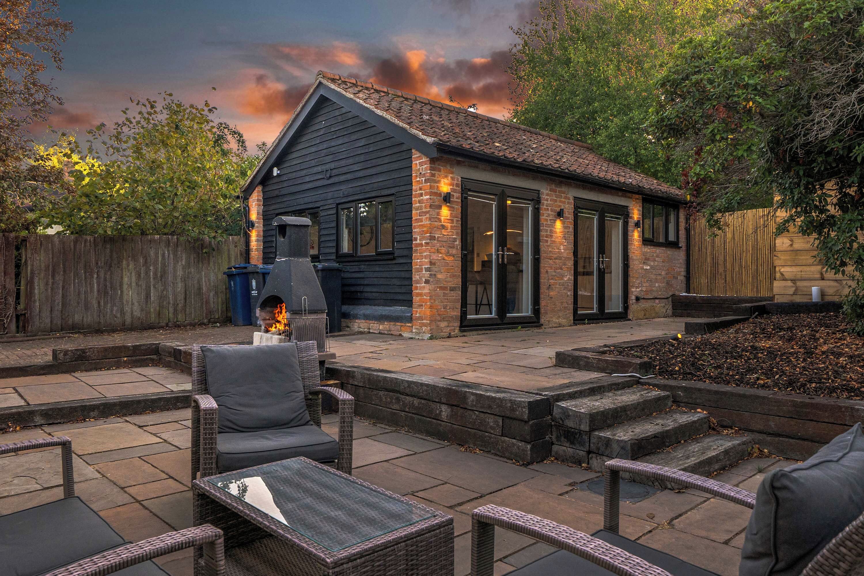 A patio area with outdoor furniture and a barbecue grill.