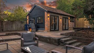 A patio area with outdoor furniture and a barbecue grill.