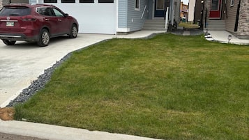 A residential property with a garage, a driveway, and a well-maintained lawn.