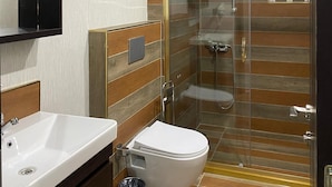 A modern bathroom with a glass shower enclosure, a white sink, and a toilet. - Armada Hotel (İstanbul)