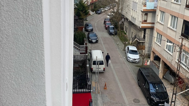 A residential street with parked cars and a person walking. - Armada Hotel (İstanbul)