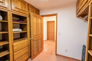 A hallway with wooden cabinets and a door leading to another room. - Hacienda Almas Gemelas – Where Luxury Meets the Sea of Cortez (Puerto Peñasco)