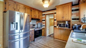 A kitchen with wooden cabinets, stainless steel appliances, and a tiled backsplash. - Waterfront Family Home w/ Dock in Poquoson! (Poquoson)