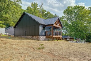 A large barn with a wooden deck and a metal roof. - Walk to the Water! Kentucky Lake Cabin (Murray)