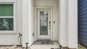 A house entrance with a white door, a green window, and a welcome mat. - Walk to Astrodome! Houston Home w/ Balcony (Houston)