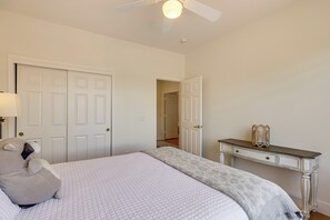 A bedroom with a bed, a nightstand, a lamp, and a dresser. - Fire Pit & Large Yard! Luxury Anthem Escape (Phoenix)