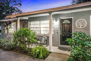 A residential house with a brick facade, a front porch with a chair, and a door with a tree decoration. - Bring Your Boat! Retreat 5 Mi to Crystal River (Homosassa)