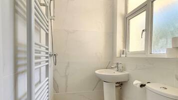 Shower, hair dryer, towels, soap