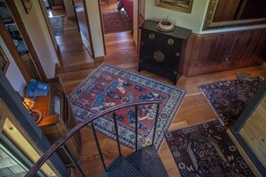 A staircase leading to a room with a patterned rug, a wooden floor, and a small table with a lamp. - Moon Shadow (TOT ID #2164): 2  BR, 2  BA House in The Sea Ranch, Sleeps 4 (The Sea Ranch)