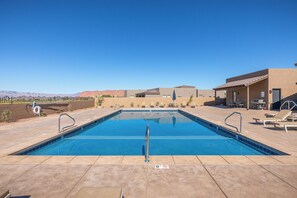 A rectangular swimming pool with a clear blue water, surrounded by a tiled deck. - Serenity on the 6th: 4  BR, 4  BA House in St. George, Sleeps 10 (St. George)