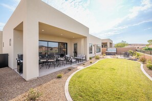 A modern outdoor patio with seating and a hot tub. - Serenity on the 6th: 4  BR, 4  BA House in St. George, Sleeps 10 (St. George)