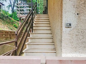 A staircase with a metal railing leading to a higher level.