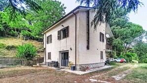 A two-story house with a stone foundation, a front door, and a small porch area. - Beautiful  villa for 5 guests with hot tub, WIFI, balcony, pets allowed and panoramic view (Rocca Sinibalda)