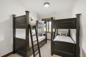 A room with two bunk beds, a ladder, a window, and a wall-mounted light fixture. - 1491 April Mountain Drive 5 Bedroom Home (Park City)