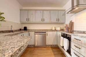 A kitchen with granite countertops, stainless steel appliances, and light wood cabinetry. - Brisa & Mar, Las Chapas, 3-Bedroom (Marbella)