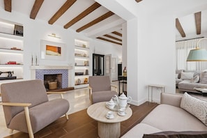 A modern living room with a fireplace, sofas, and a coffee table. - Villa Irene · Heated Pool · Pedregalejo (Málaga)