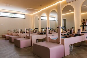 A Pilates studio with equipment arranged in rows, large windows, and a clean, modern interior. - Estepona Hills Luxury Resort 3-Bedroom Apartment (Estepona)