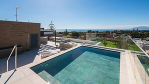 A rooftop pool with a clear view of the cityscape and mountains in the distance. - Sky Penthouse with Private Pool (Artola)