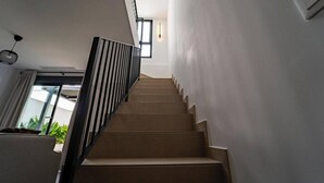 A staircase with a modern design, leading to an upper floor. - Charming Townhouse in Cancelada Village (Cancelada)