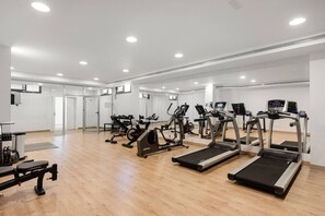 A gym with treadmills, elliptical machines, and weightlifting equipment. - Venere Retreat: Serenity and Design (Marbella)