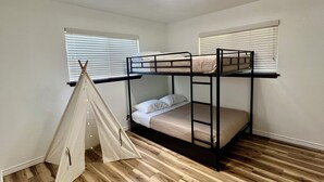 A room with bunk beds, a tent, and a ceiling fan. - Backyard Paradise by Lackland Pool+Hot tub+King Beds+Games (San Antonio)