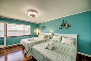 A room with two beds, a window with a view of the water, and a ceiling fan. - Villa Fun In The Sun, Lakefront Oasis with Heated Pool & Private Dock........ (Cape Coral)
