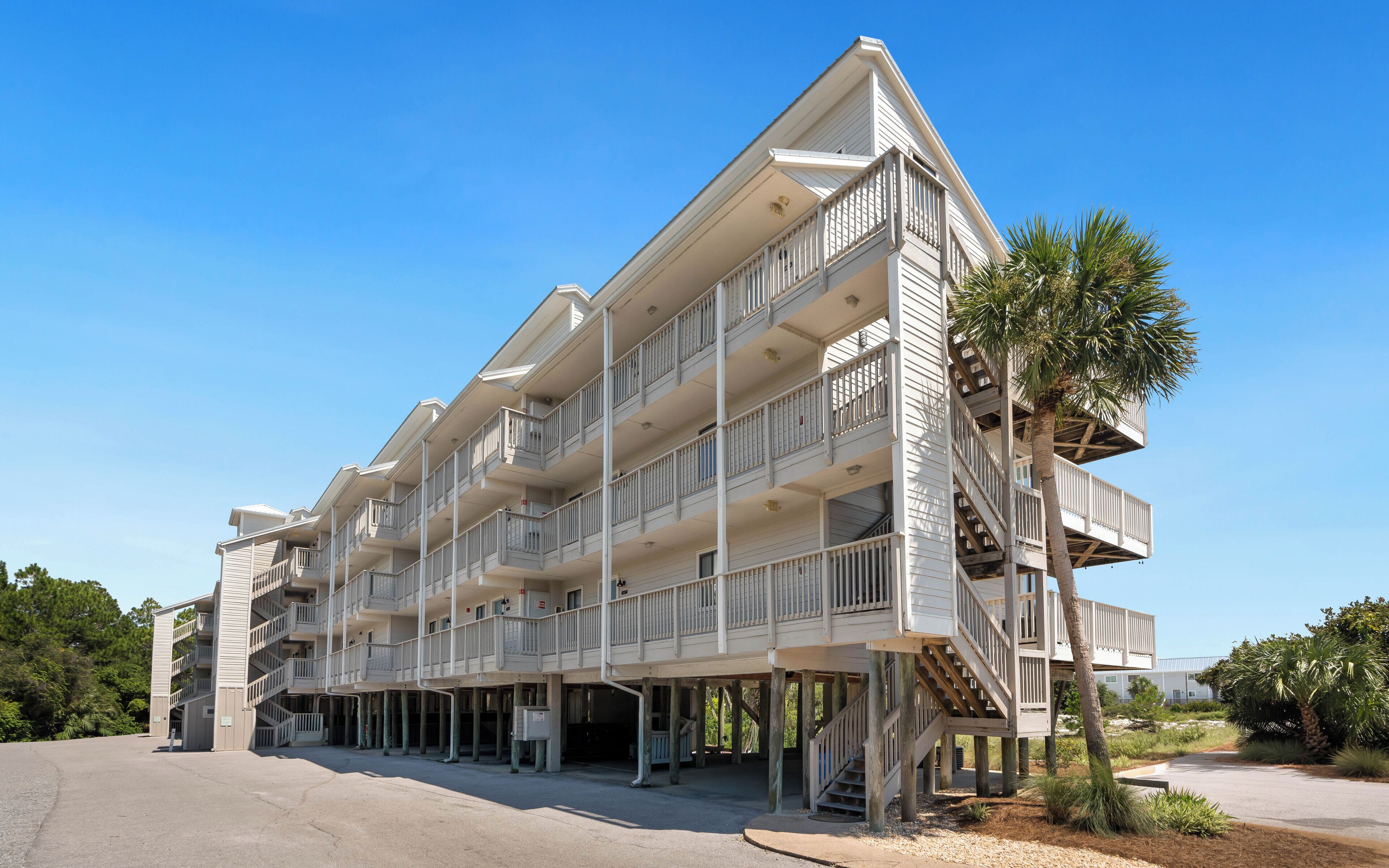 A multi-story hotel with balconies and a covered outdoor area.