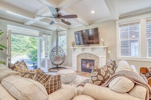 A cozy living room with a fireplace, comfortable seating, and a television. - Family & Dog friendly Nedonna Beach Home, Hot Tub, BBQ, Short Walk to the Beach (Rockaway Beach)