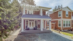 Une maison à deux étages avec un porche abrité, un garage et une allée.