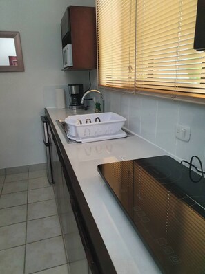 A kitchen with a microwave, coffee maker, and a sink. - Marina Loft #103, 1 Floor (Sardinal)