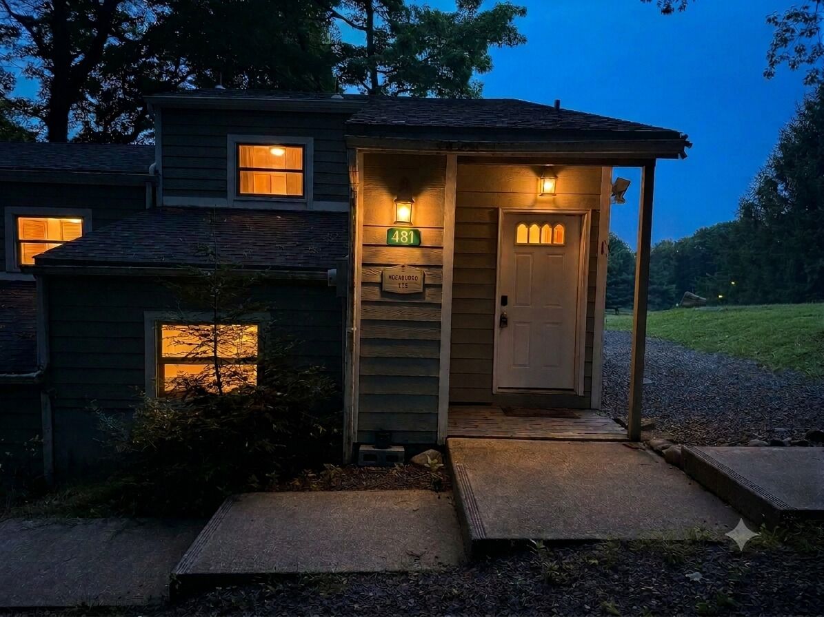 A house with a porch, a door, and a mailbox.