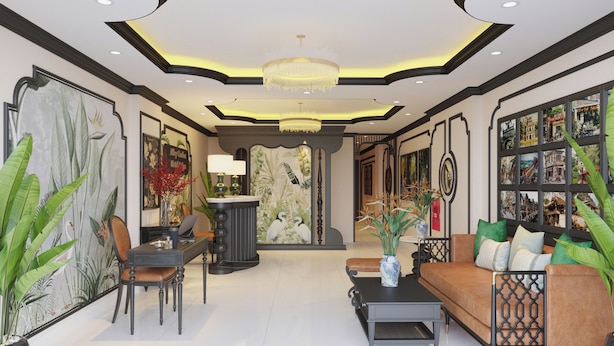 A spacious lobby with a modern chandelier, a seating area with a sofa and coffee table, and a large wall with framed pictures. - Alley Garden Hotel & Spa (Hanoi)