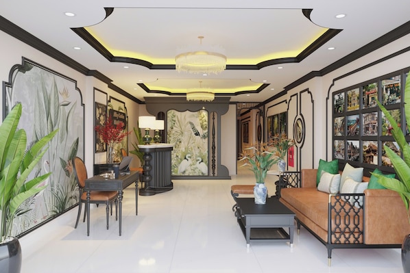 A spacious lobby with a modern chandelier, a seating area with a sofa and coffee table, and a large wall with framed pictures. - Alley Garden Hotel & Spa (Hanoi)